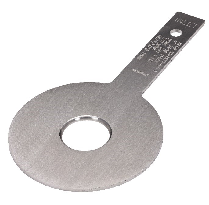 Figure 1: A concentric orifice is a very common primary element for DP flow meters. The plate, bore, and beveled edge are all machined to exacting specifications, and then bolted between two orifice flanges, each with integral sensing ports.