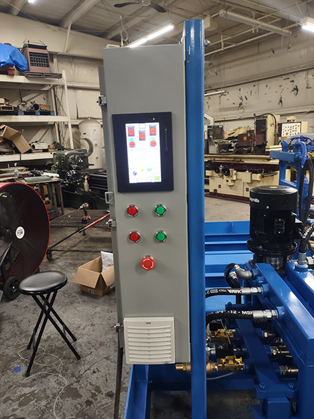 Figure 1: The control panel for the automated casting test system utilizes the side of the electrical enclosure for the operator interface. The AutomationDirect C-More HMI Touch Panel mounted in portrait mode had the ideal footprint.