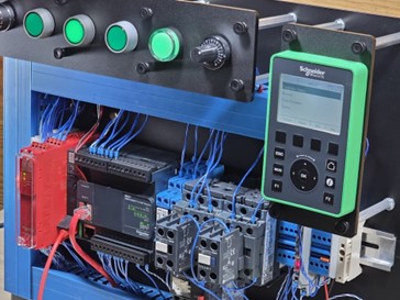 Figure 1: Picture of a PLC trainer featuring a Schneider Modicon PLC and HMI.