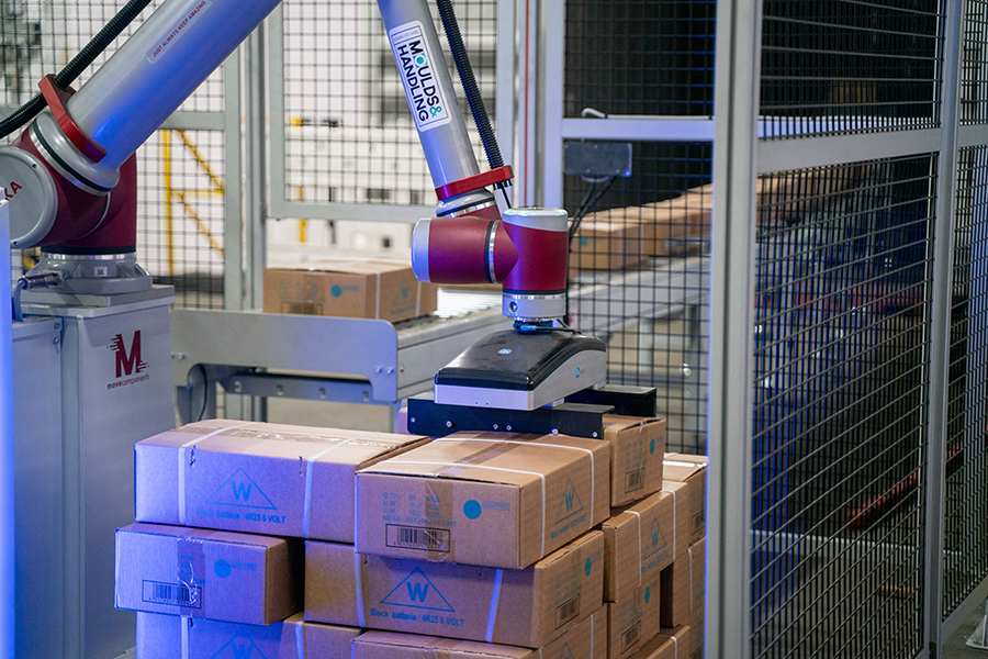 Figure 1: The unloading of heavy battery boxes at WEMAS Absperrtechnik GmbH used to be a low-efficiency task requiring two operators. An off-the-shelf robotic palletizing solution provided same-day installation and ultimately delivered $31,000 in annual cost saving. Source: OnRobot