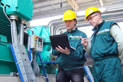 Industrial workers with notebook, teamwork