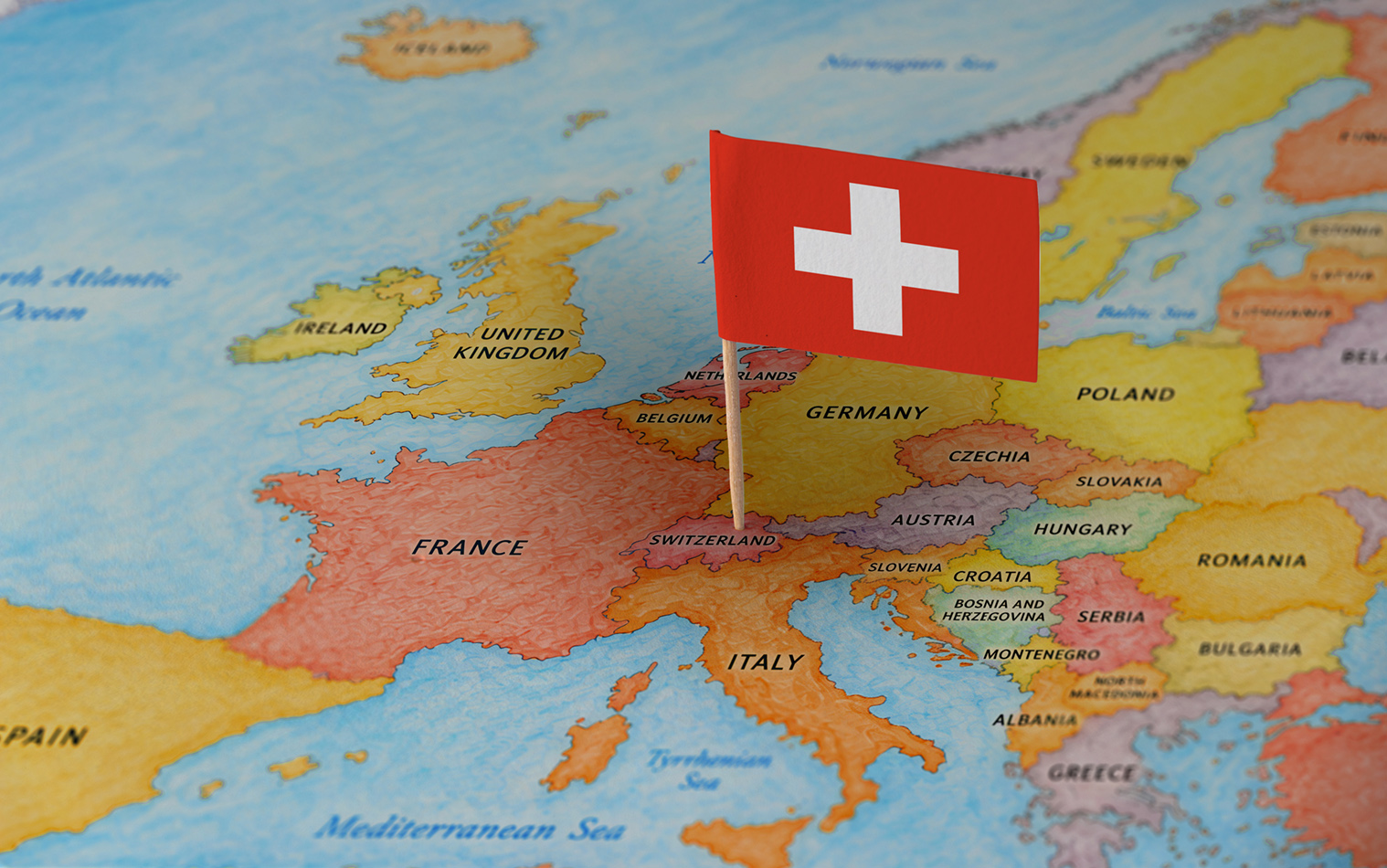 Switzerland flag pin marking Switzerland on a map of Europe.