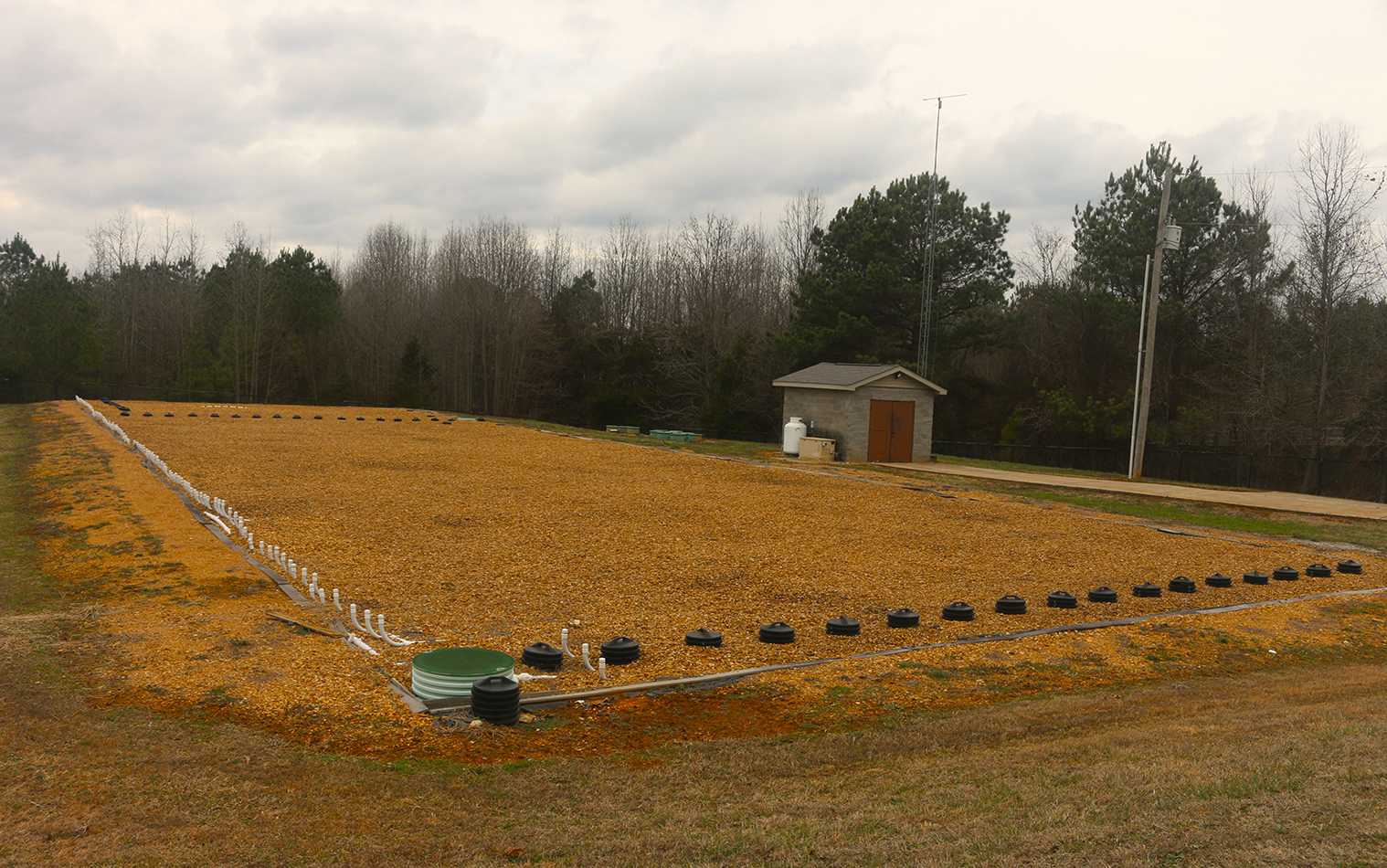 Typical sand filter bed, with controls housed in adjacent shed. RF antenna implemented for remote monitoring and control.